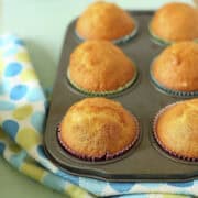 6 fairy cup cakes in a muffin tin.