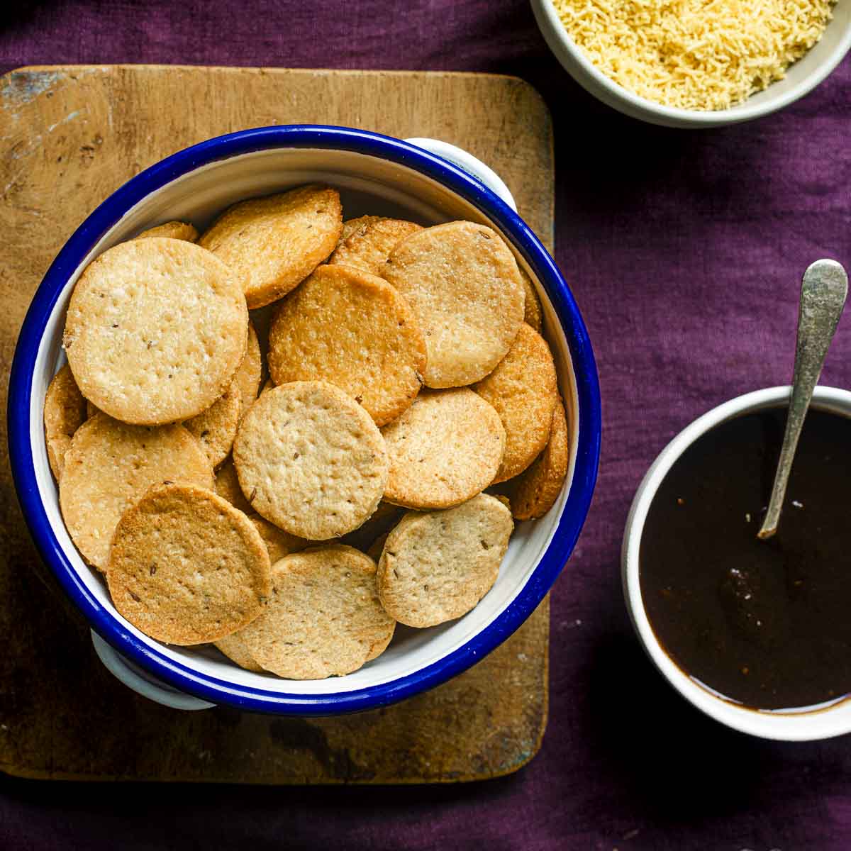 papdi for chaat, sev, dates tamarind chutney on a purple background.