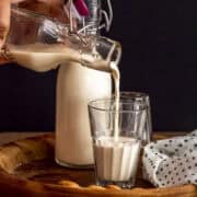pouring almond milk in a cup.