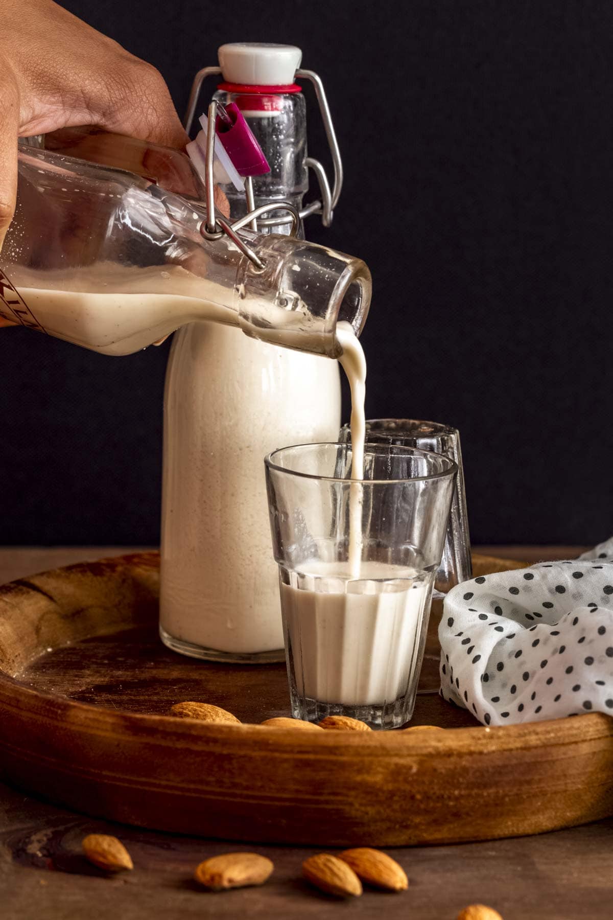 pouring almond milk in a cup.