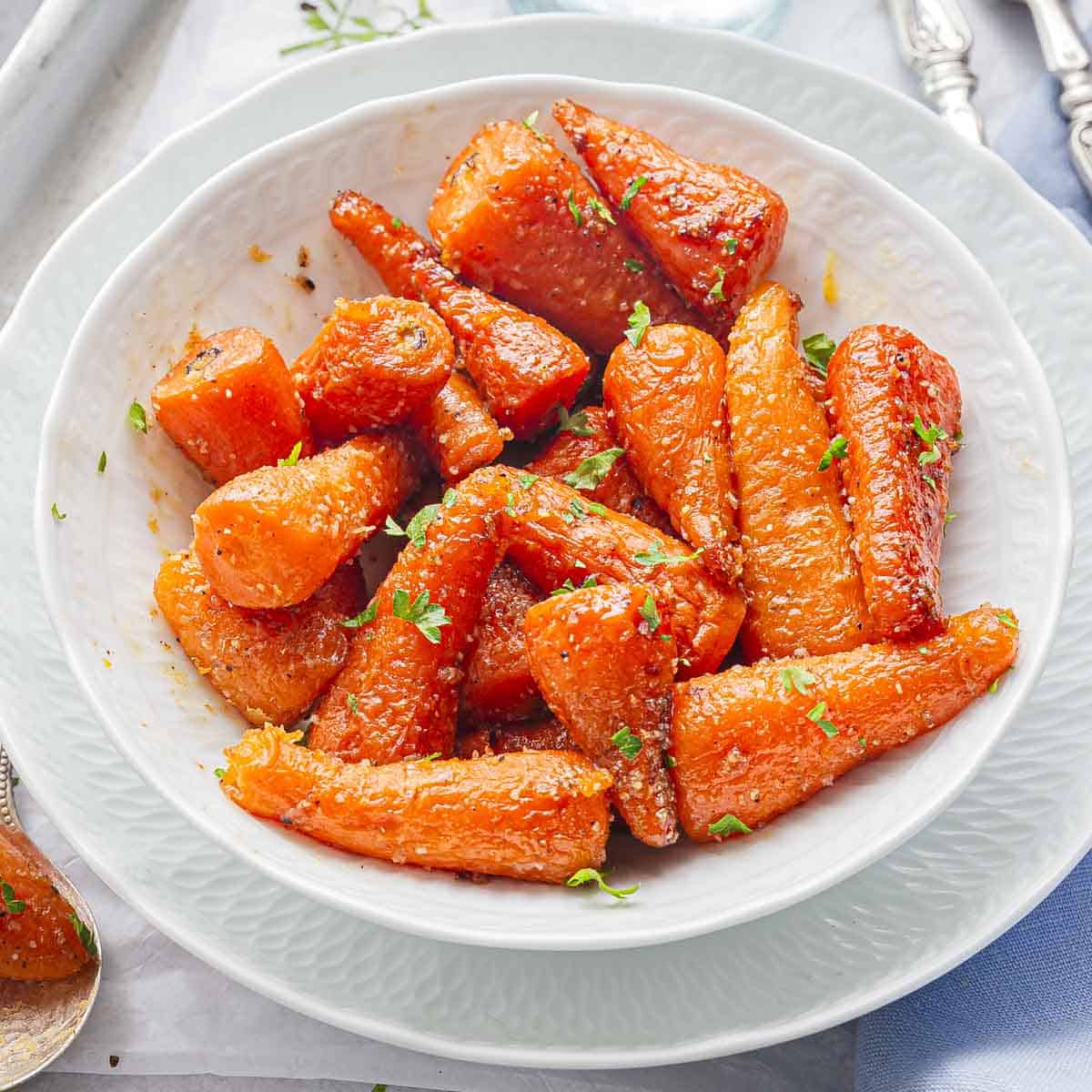 a white bowl full of instant pot glazed carrots.