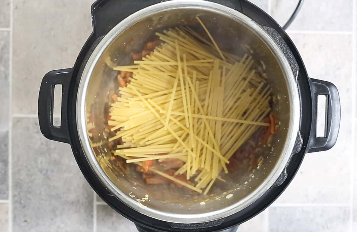 add noodles on top of veggies and sauce to make Thai peanut noodles in Instant Pot.