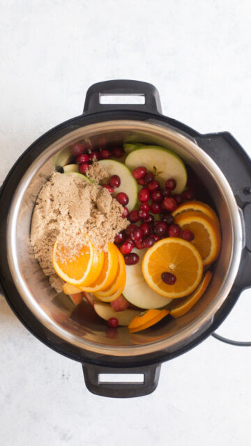 Ingredients for apple cider in the inner pot of instant pot.