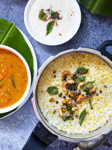ven pongal served in a pressure cooker pan, sambar and coconut chutney