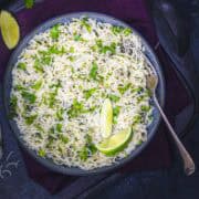 cilantro lime rice served on a bowl with lime wedges.