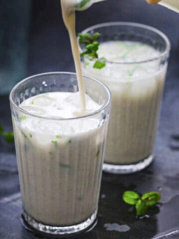 pouring spicy masala lassi in glasses