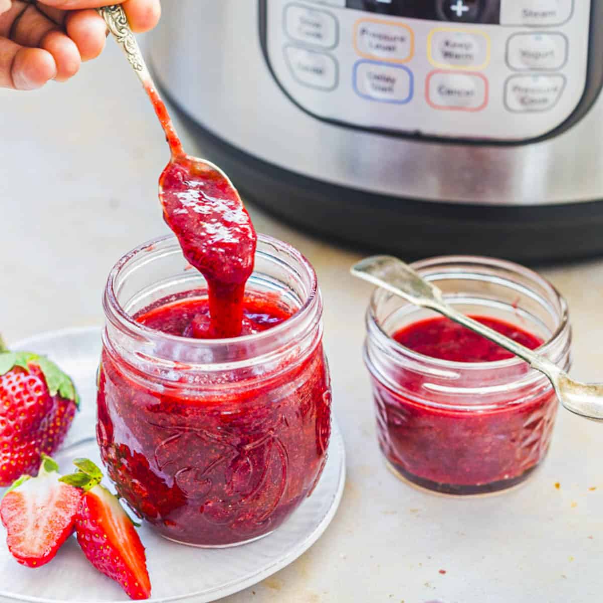 two mason jars of instant pot strawberry jam.