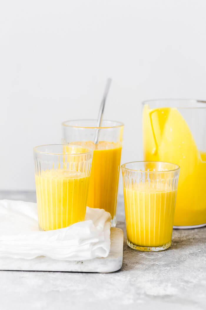mango lassi served in glasses.