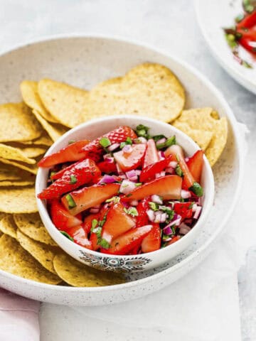a bowl of strawberry salsa served with tortilla chips