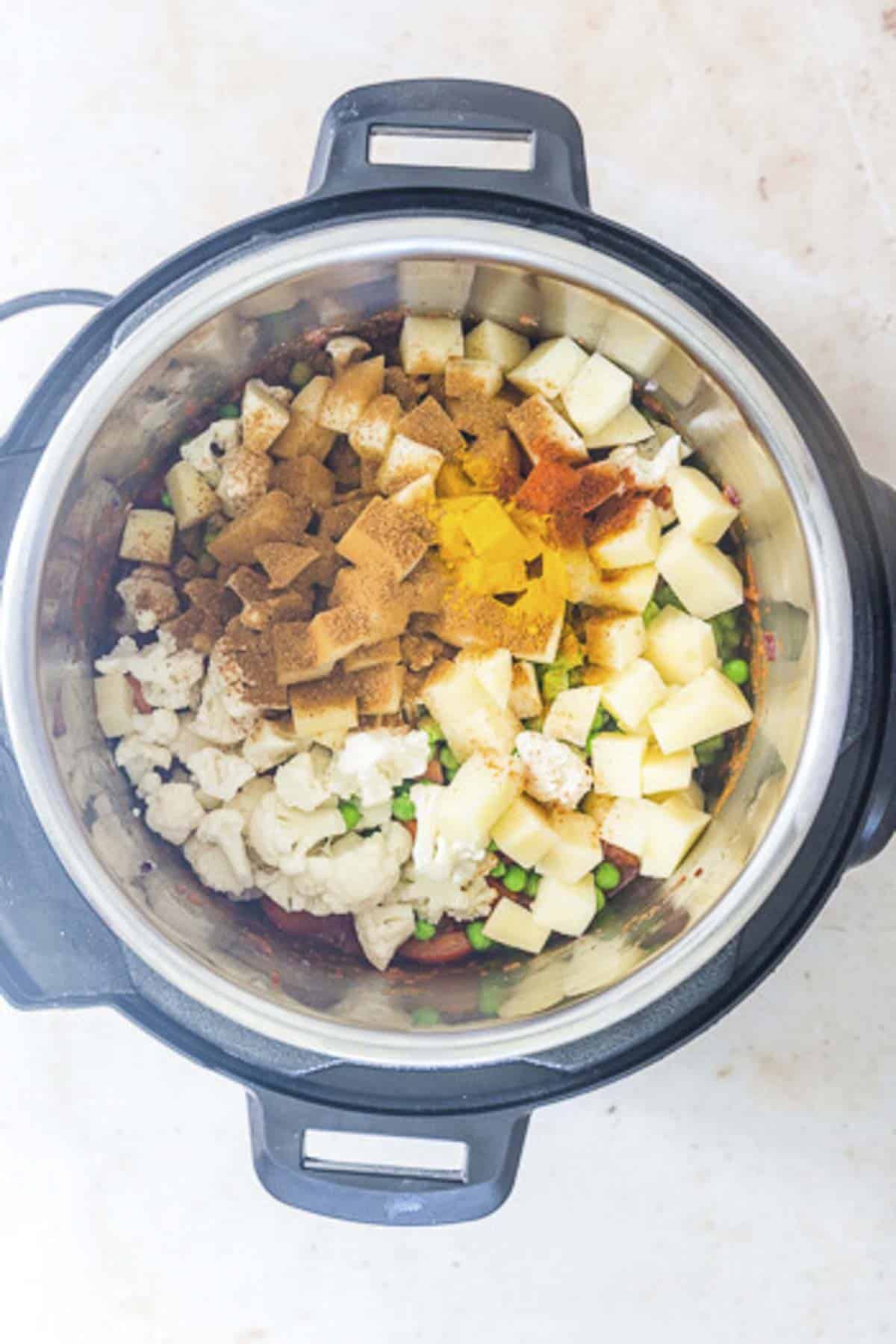 add vegetables and spices to the instant pot.
