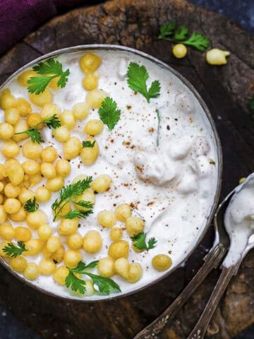 boondi raita served in a bowl with crunchy boondi, fresh coriander.