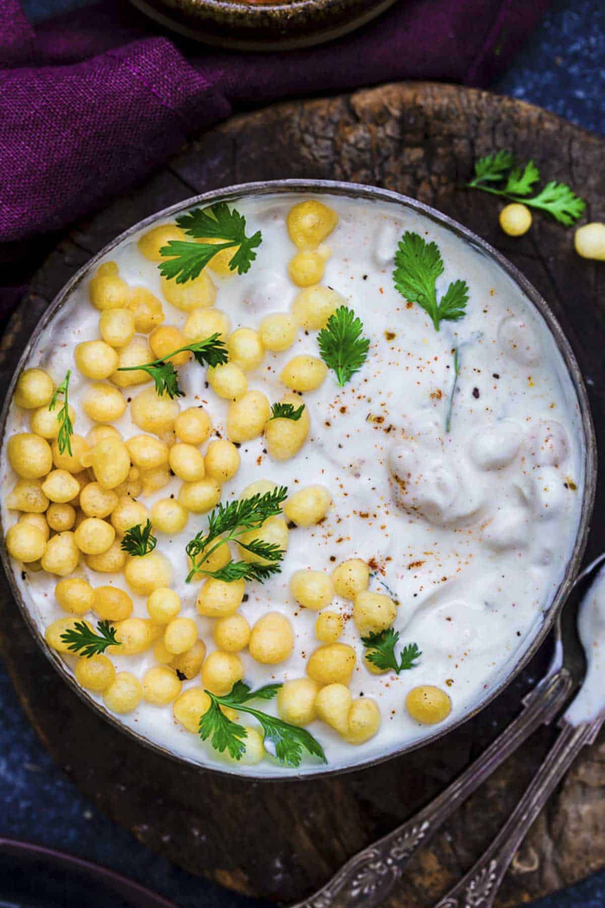 boondi raita served in a bowl with crunchy boondi, fresh coriander.