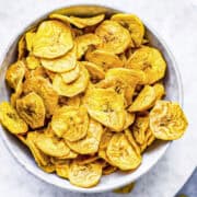 a white bowl of air fryer plantain chips.