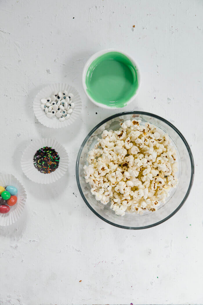 pre popped popcorn, candy melt and sprinkles on white background.
