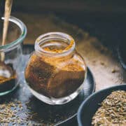 fresh homemade ground cumin powder in a bottle.