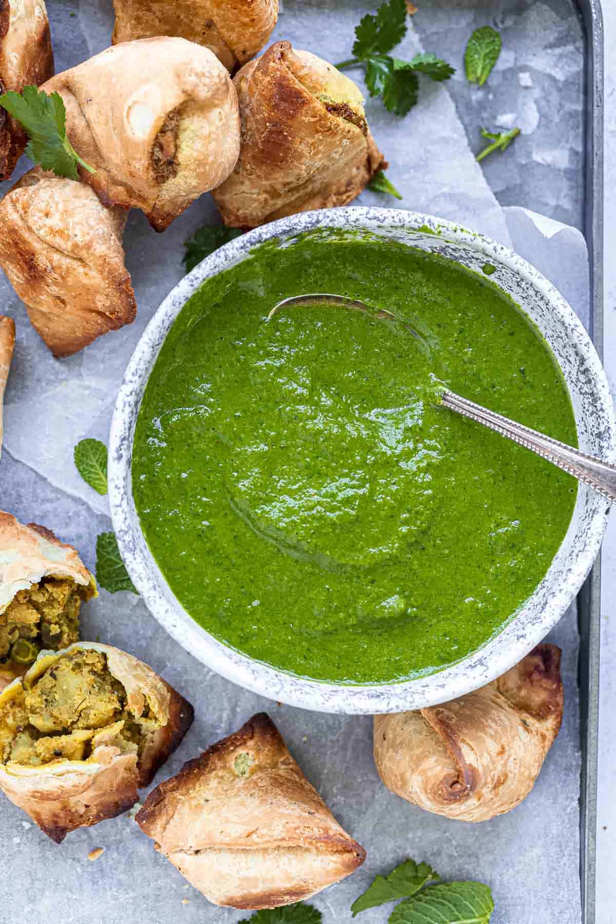 Indian mint coriander chutney served with samosas