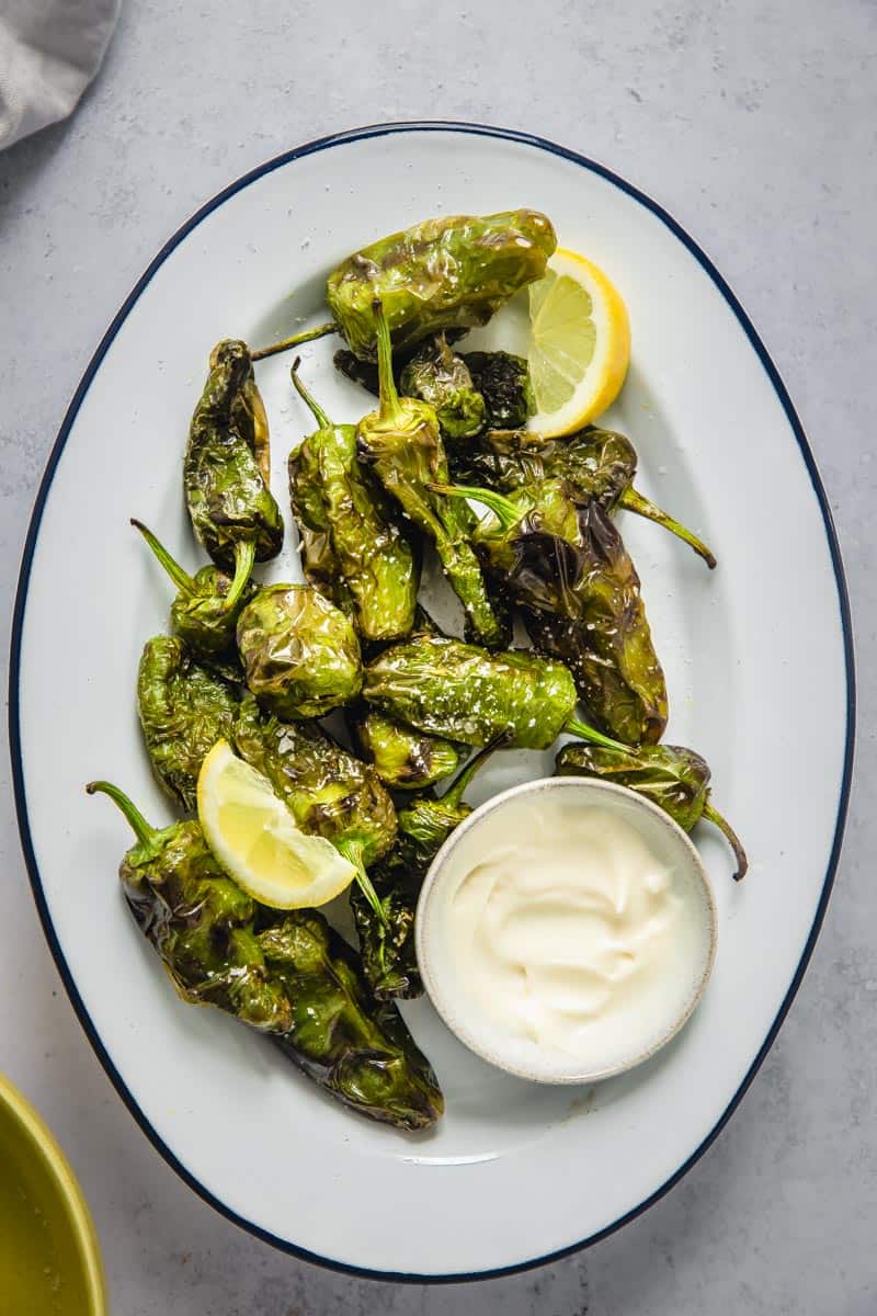 air fried shishito peppers in a oval plate.
