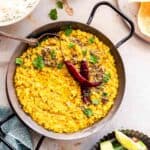 red lentils tarka dal served with rice,poppadom and kachumber salad