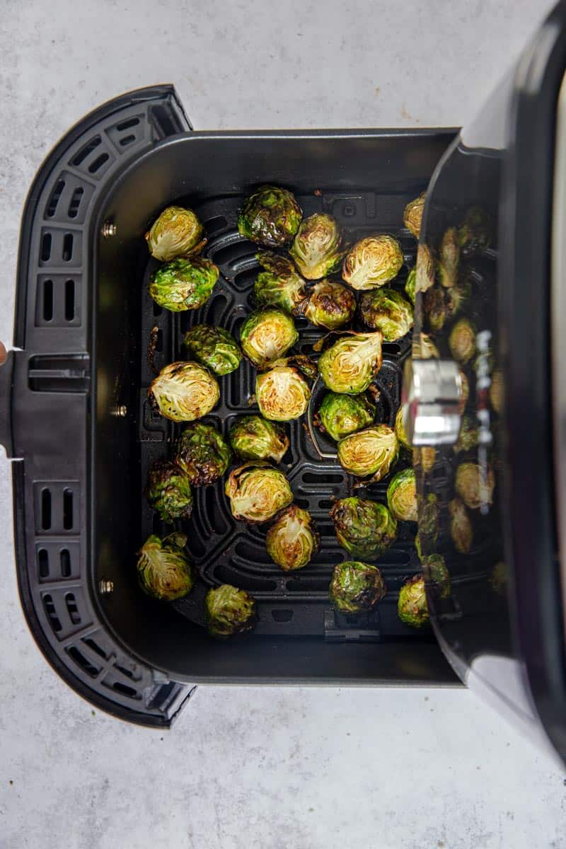 crispy balsamic glazed air fried brussels sprouts in the air fryer basket.