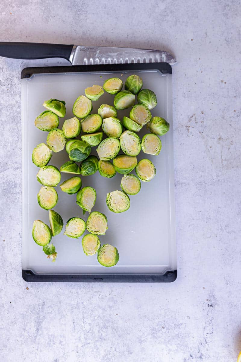 halved brussels sprouts on a chopping board.