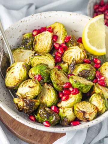 air fryer roasted brussels sprouts served with lemon and pomegranate