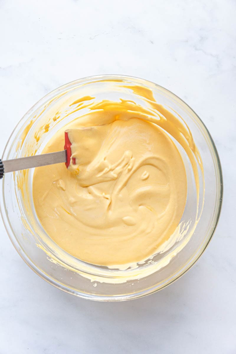 fold the ingredients together to make an eggless mango mousse.
