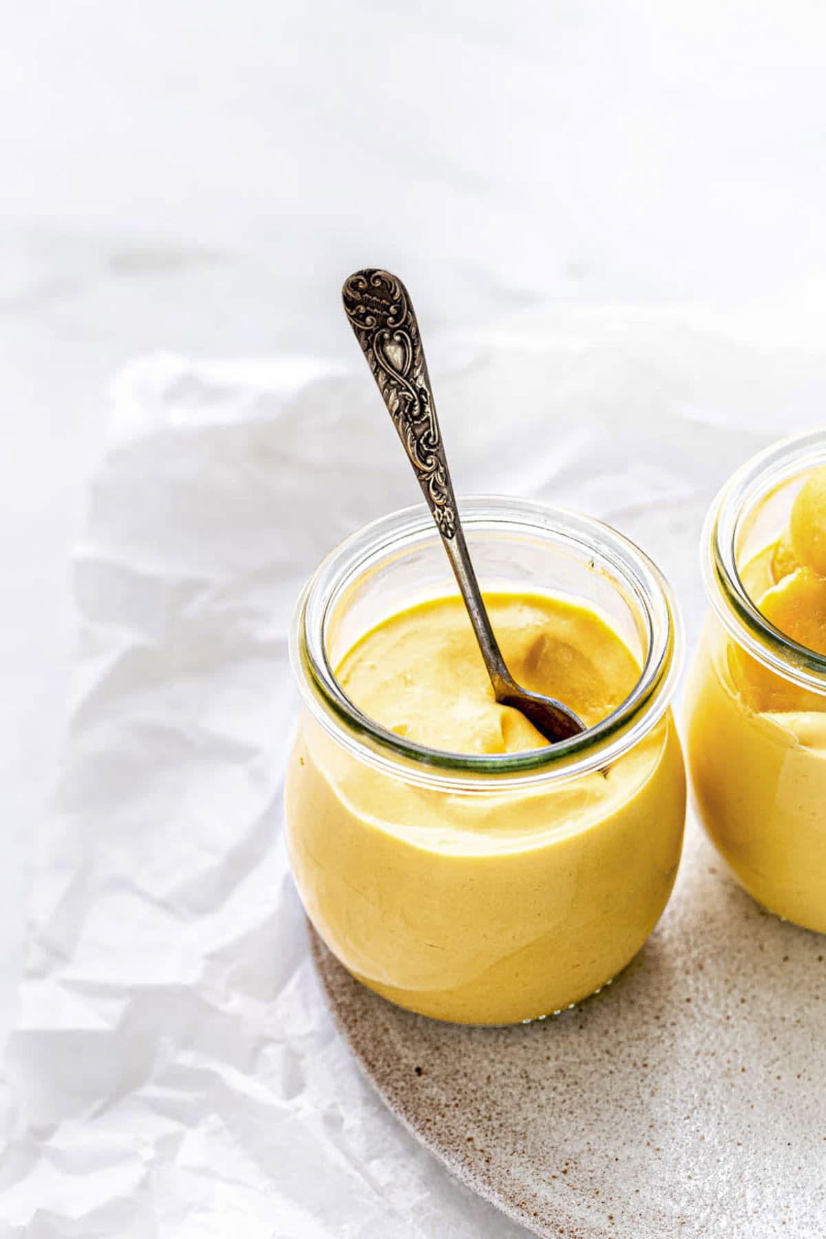 Two Mango Mousse Cups without garnishes.
