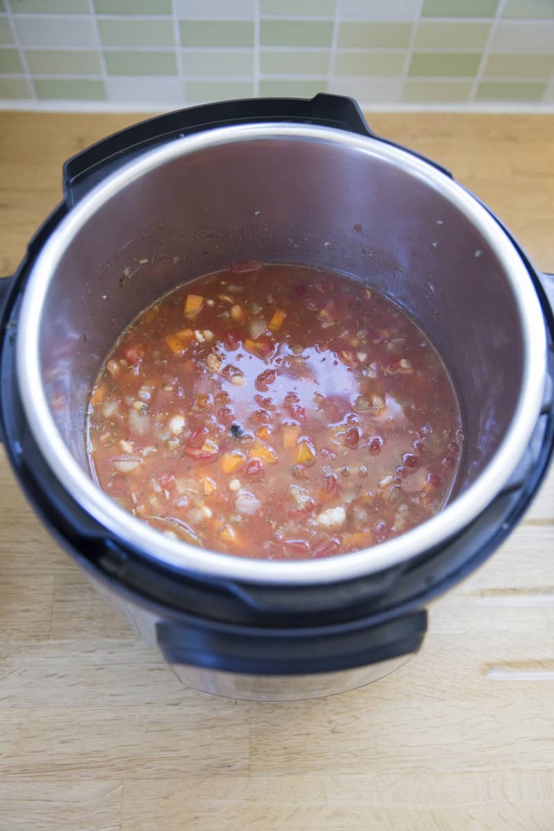 Add the vegetable stock or broth to make vegetarian bean soup.