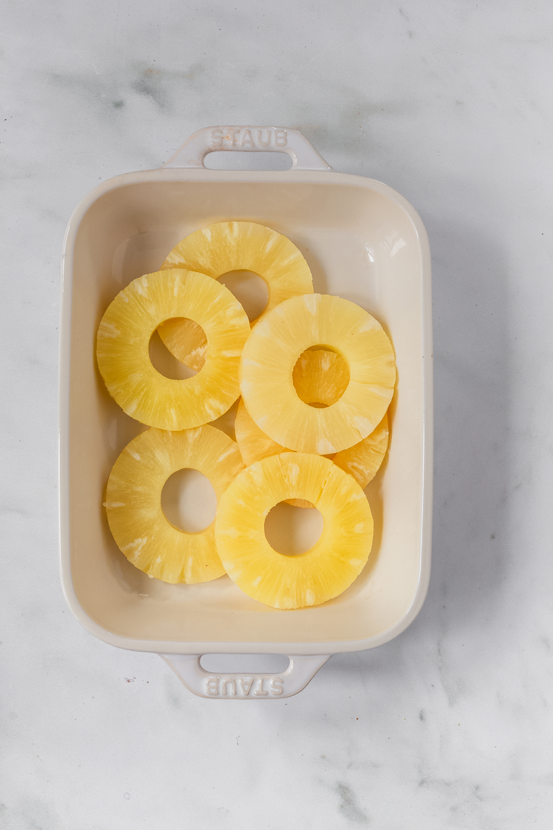 pineapple rings in a shallow white dish.