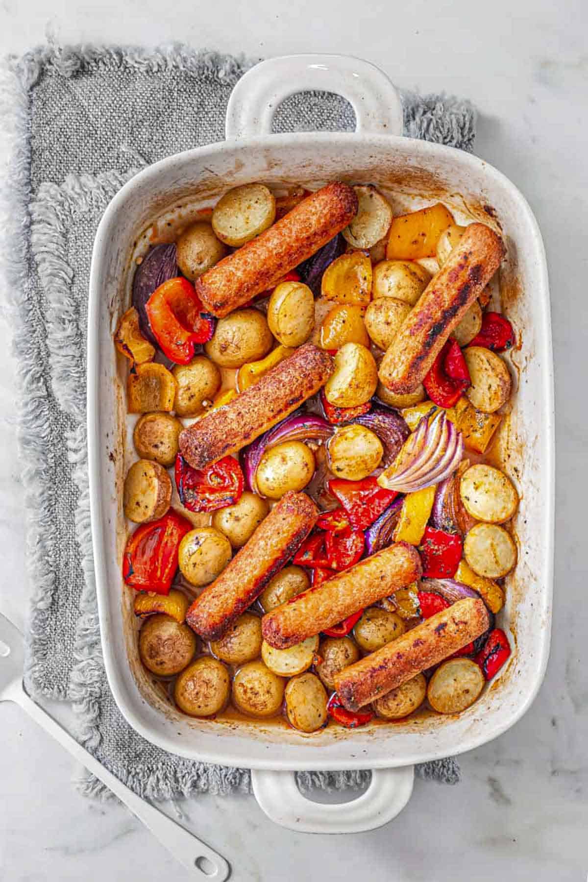 Sausage Potato baked in a white casserole dish.