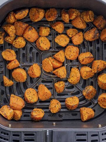 roasted carrots in air fryer basket.
