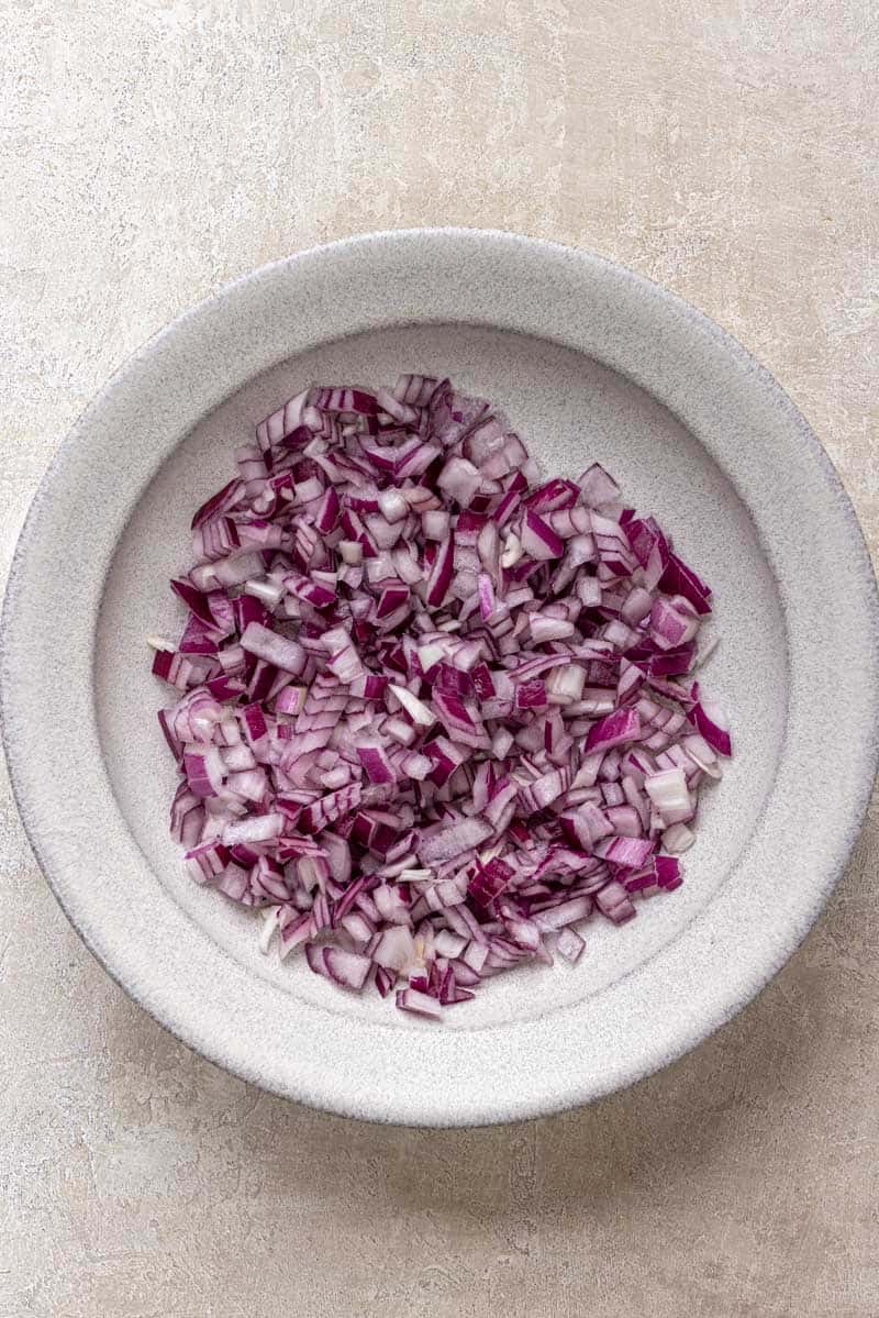 add drained red onion to the white bowl.