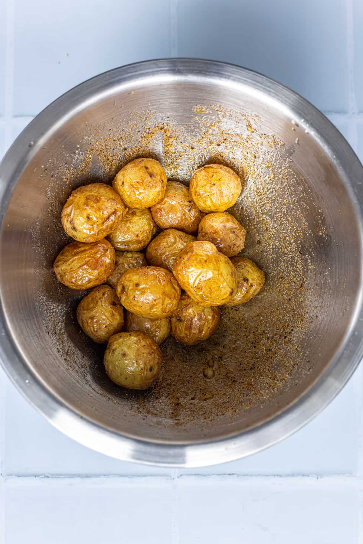 Toss the air fried potatoes with spices