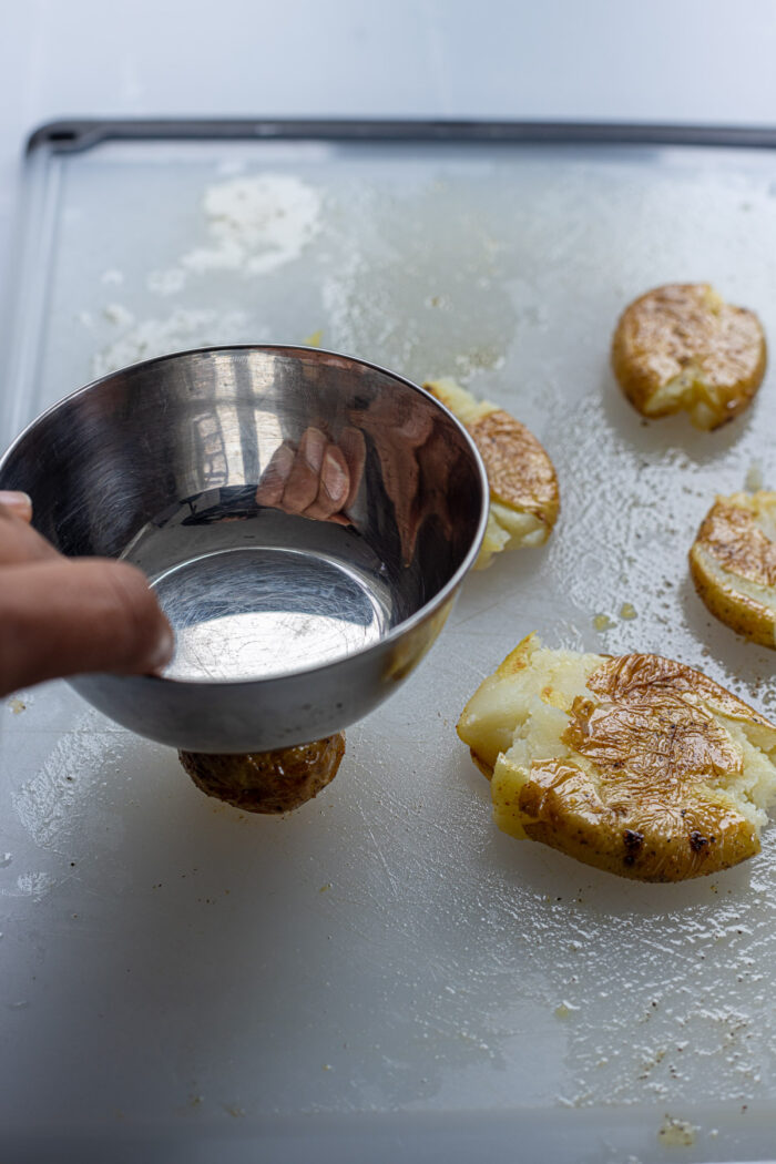 smash the potatoes with bowl