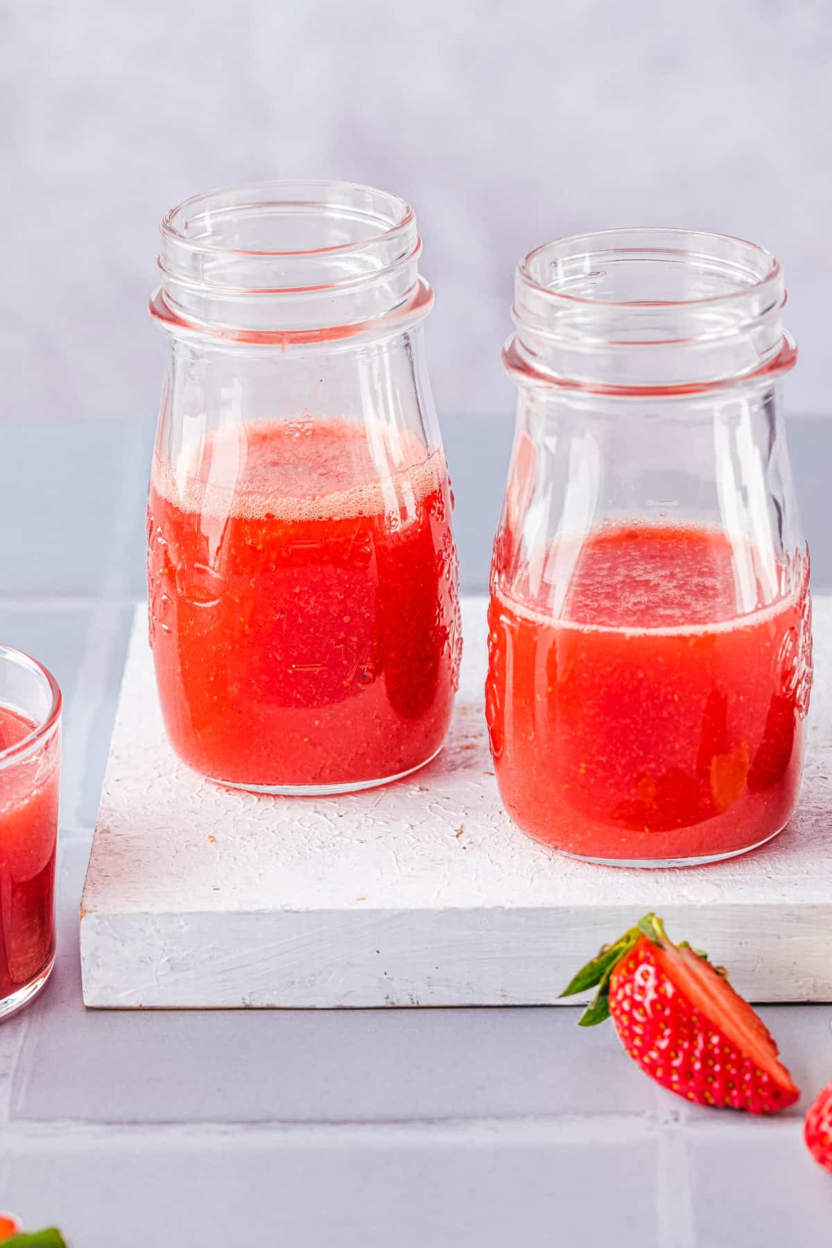 two bottles of fresh serving of homemade strawberry juice