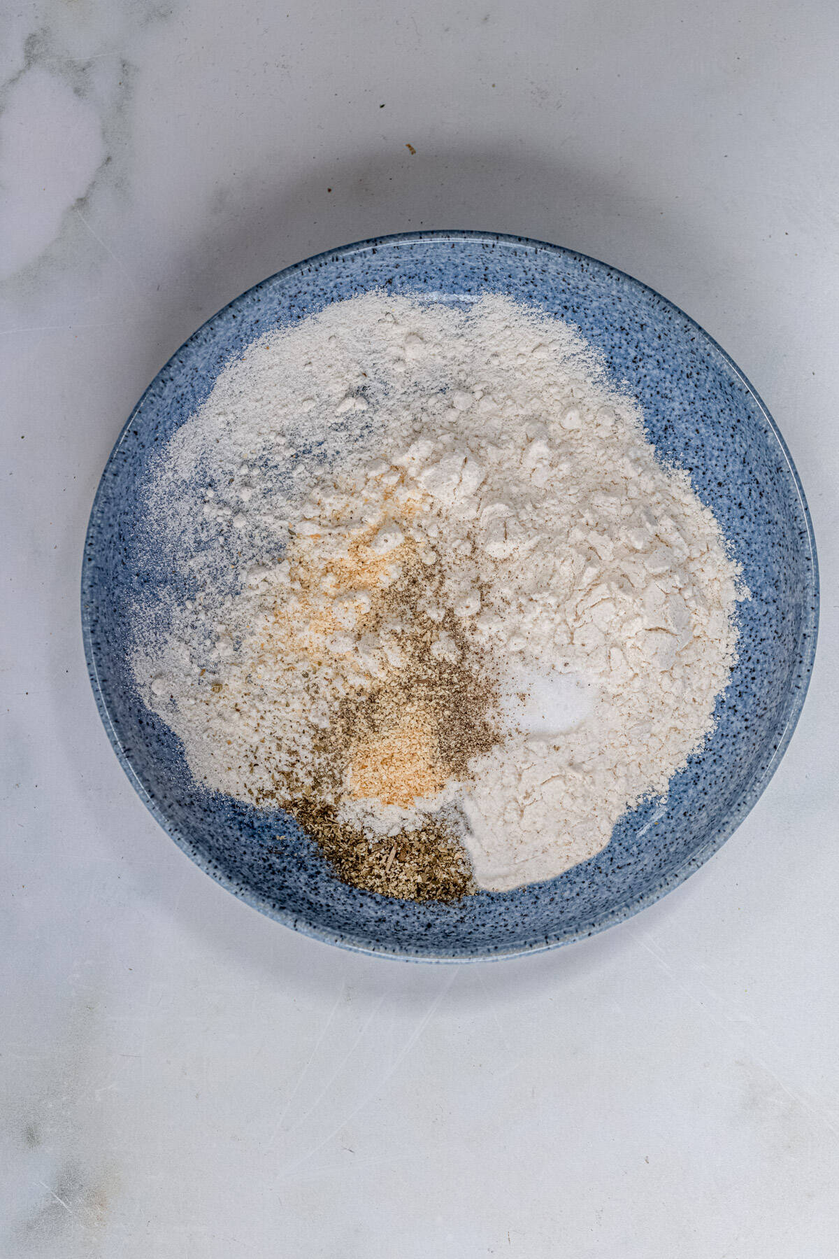 Combine the flour and seasoning in a bowl.