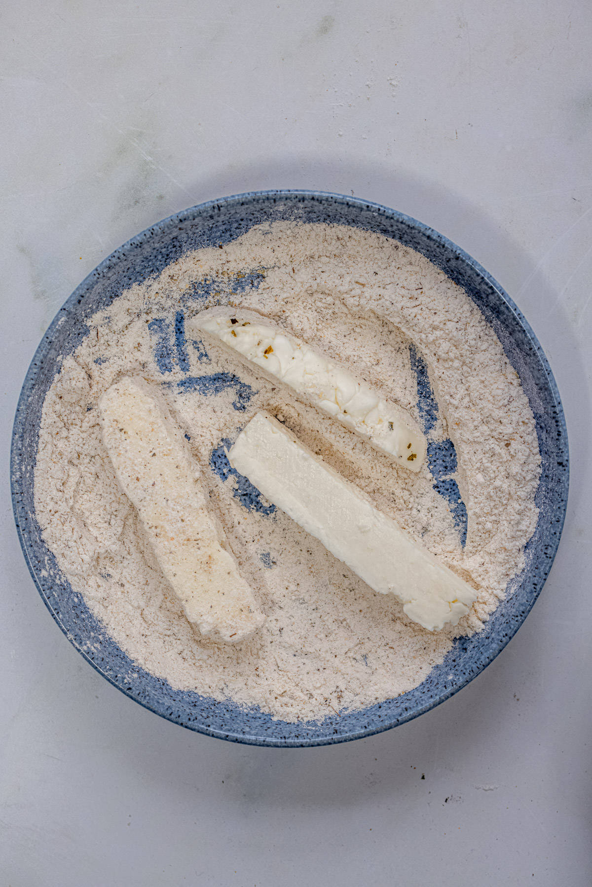 halloumi sticks coated in plain flour and seasoning mixture