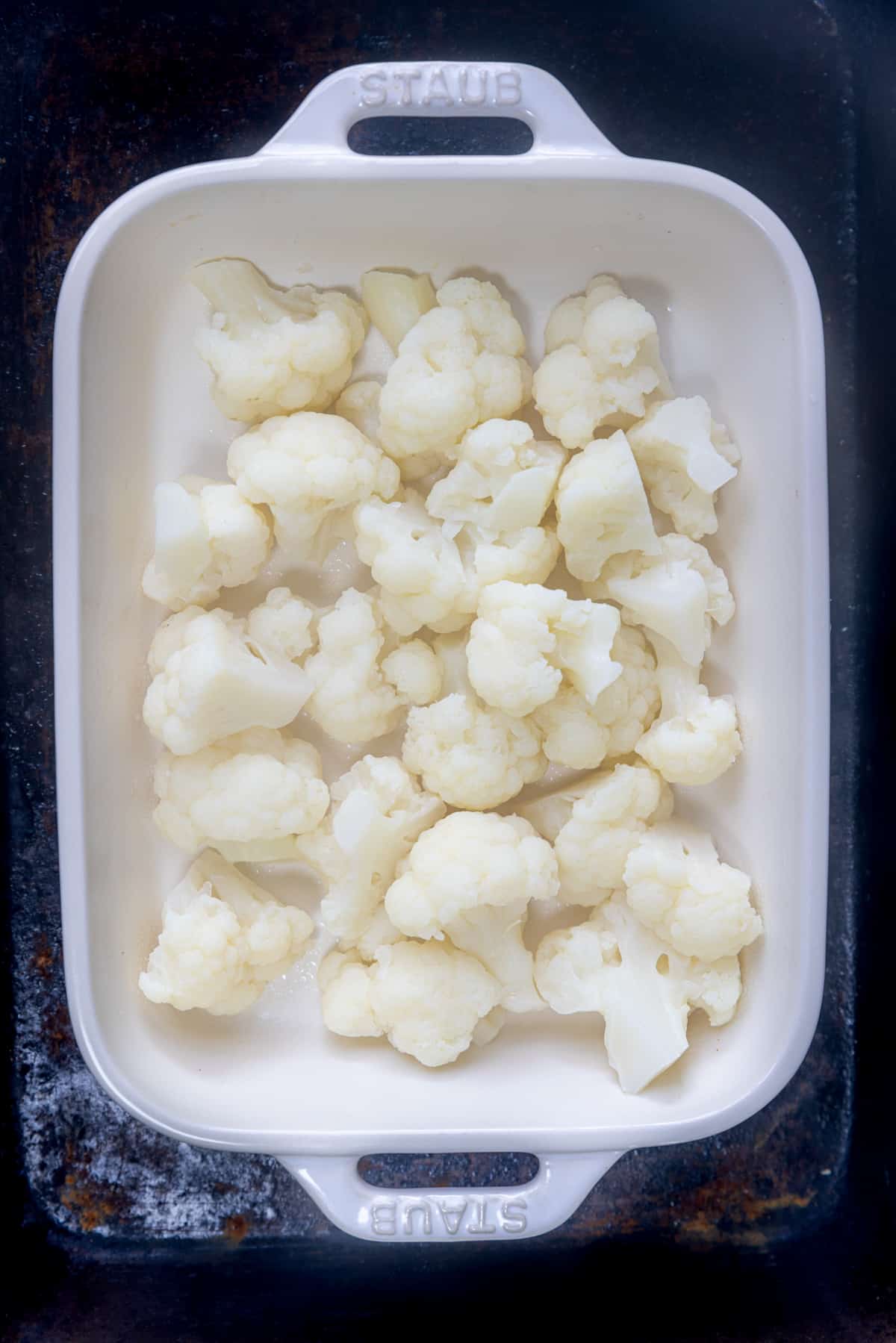 cooked cauliflower in a baking dish.