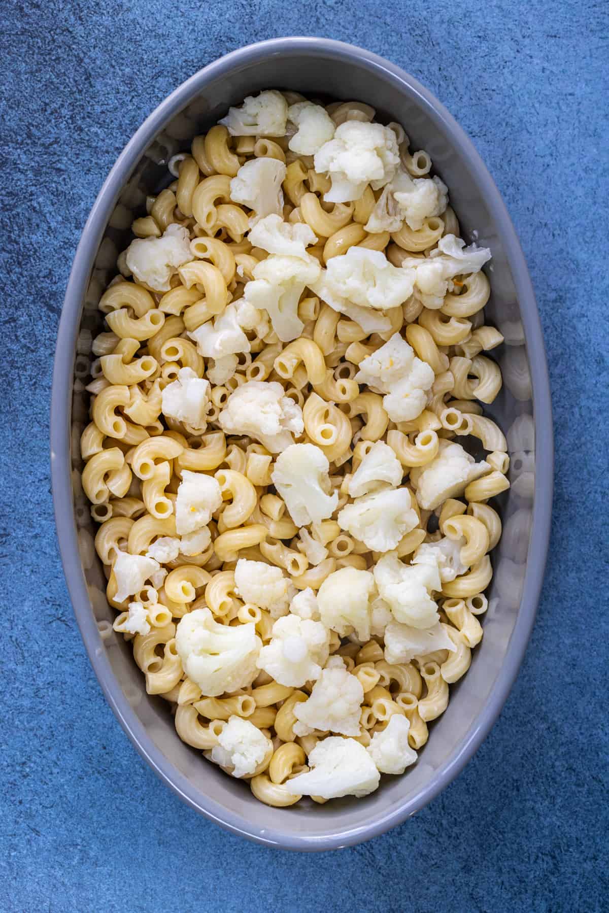 add the cauliflower and macroni in the oval oven proof dish.