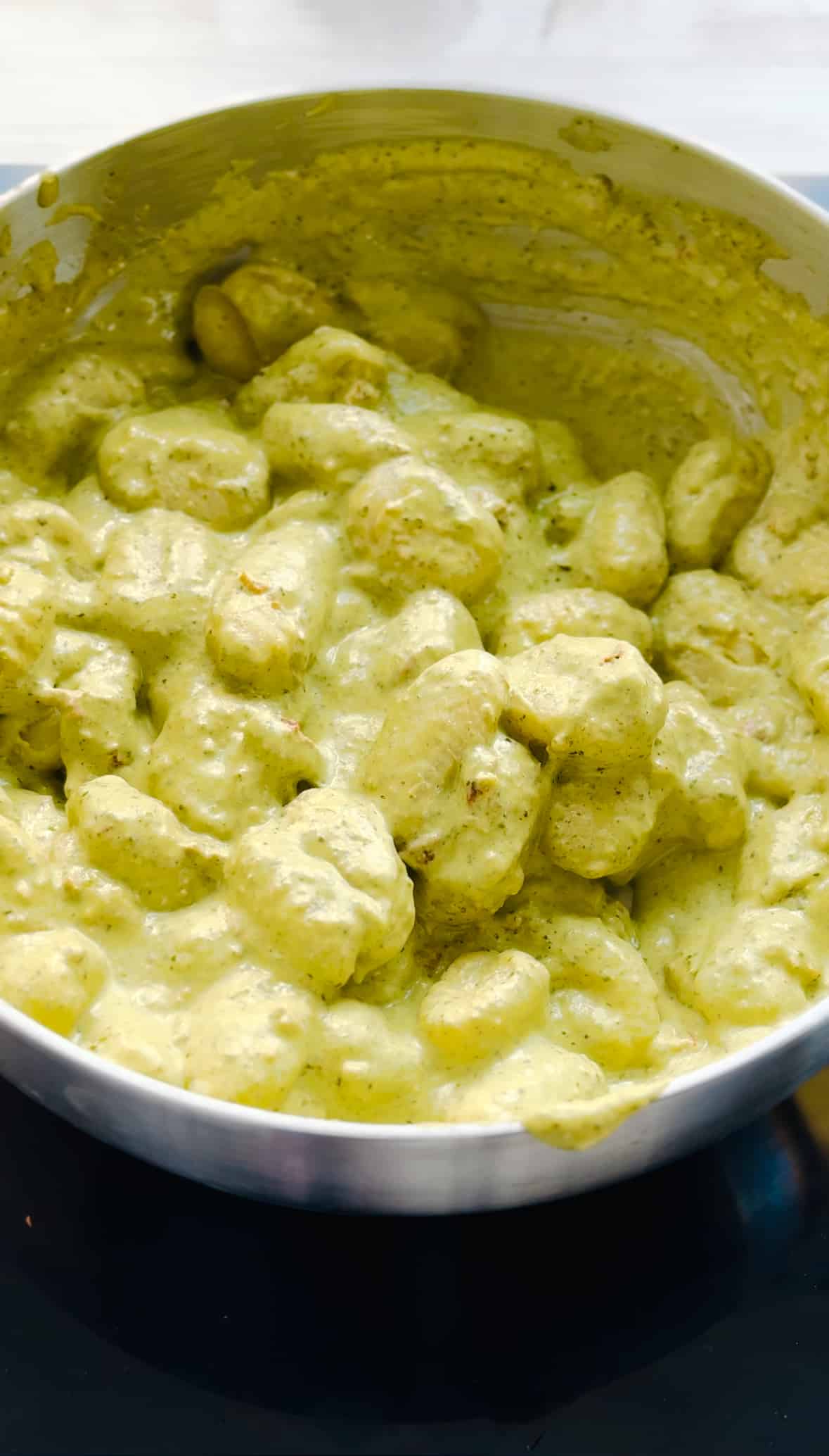 combine the gnocchi with the creamy pesto sauce.