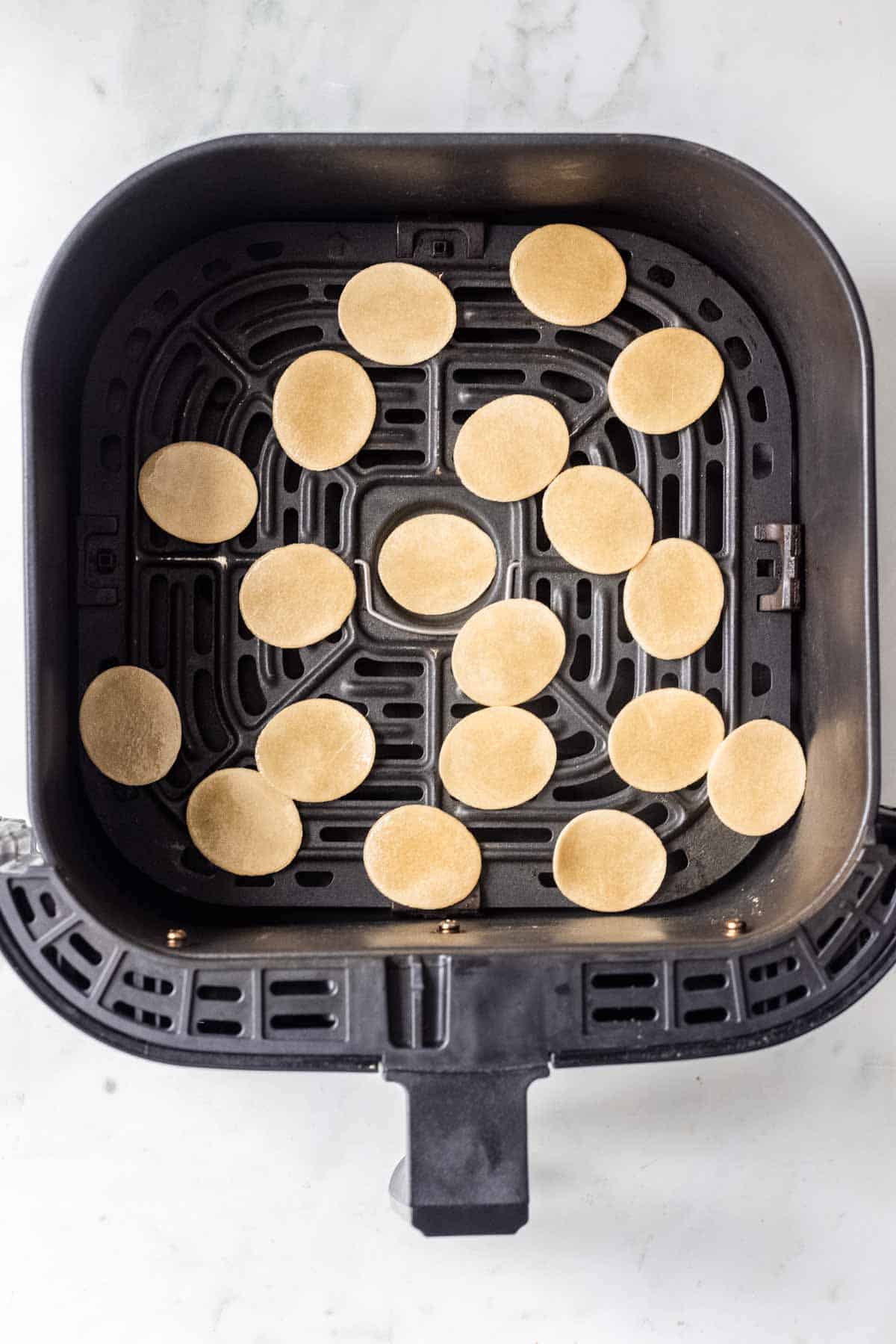 22 pani puri pellets in air fryer basket.