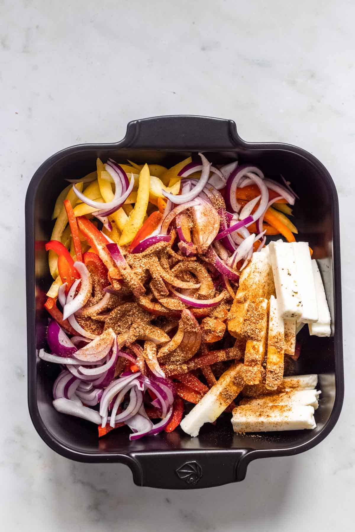 halloumi tray bake ingredients in a baking dish