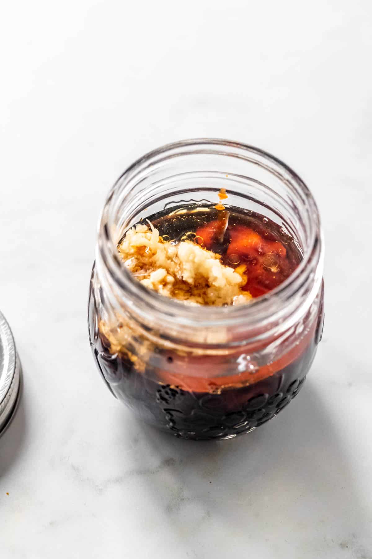 all the ingredients for vegan stir fry sauce in a mason jar.