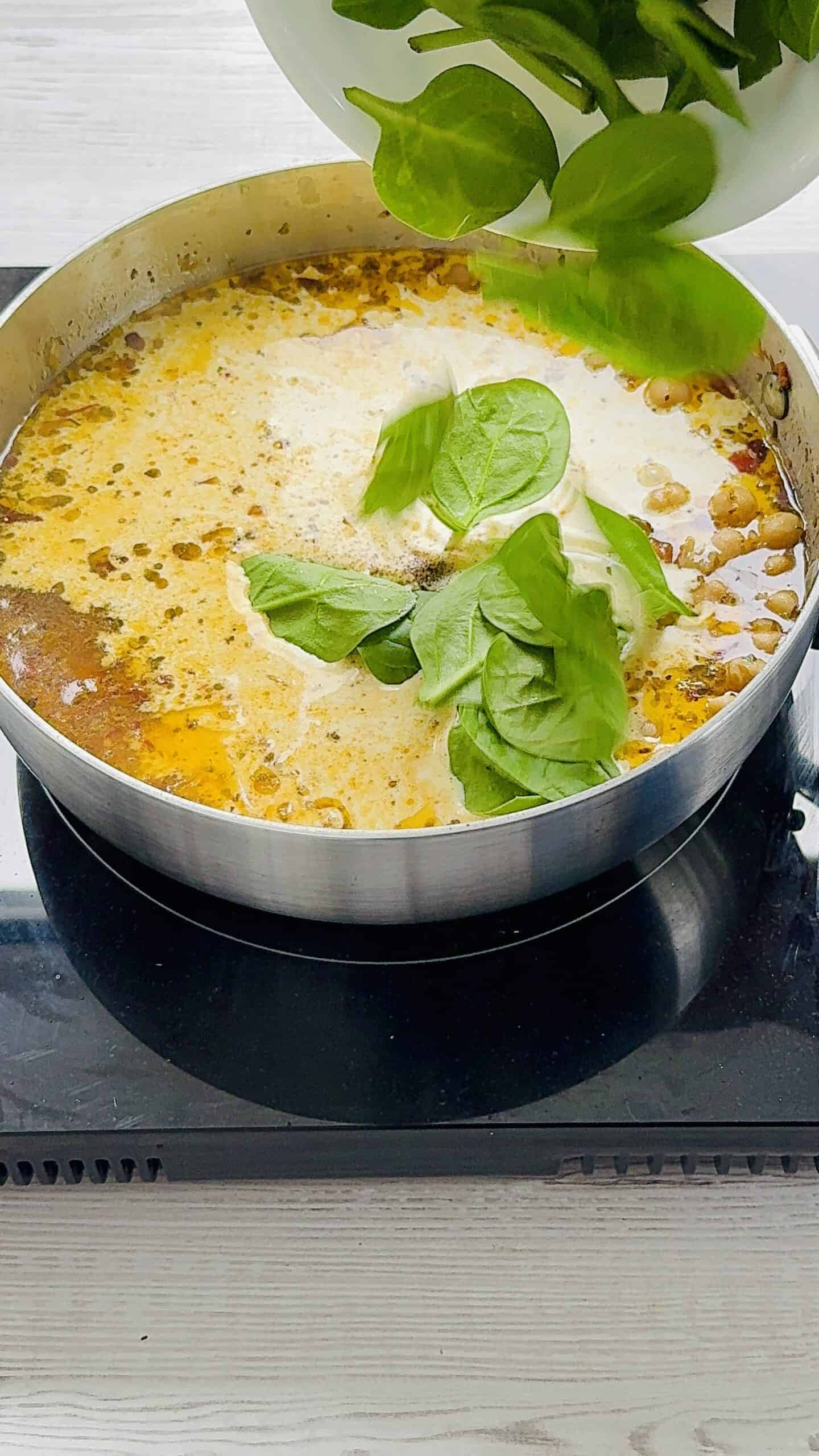 cream and spinach in a pan.
