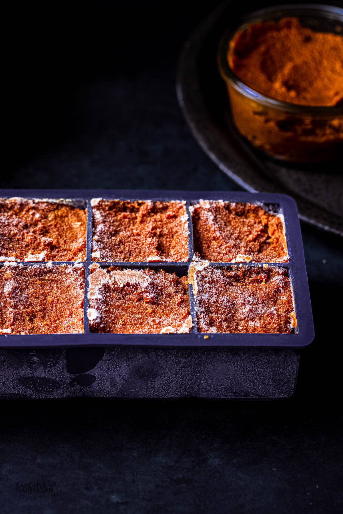 indian curry sauce masala in ice cube trays for freezing.
