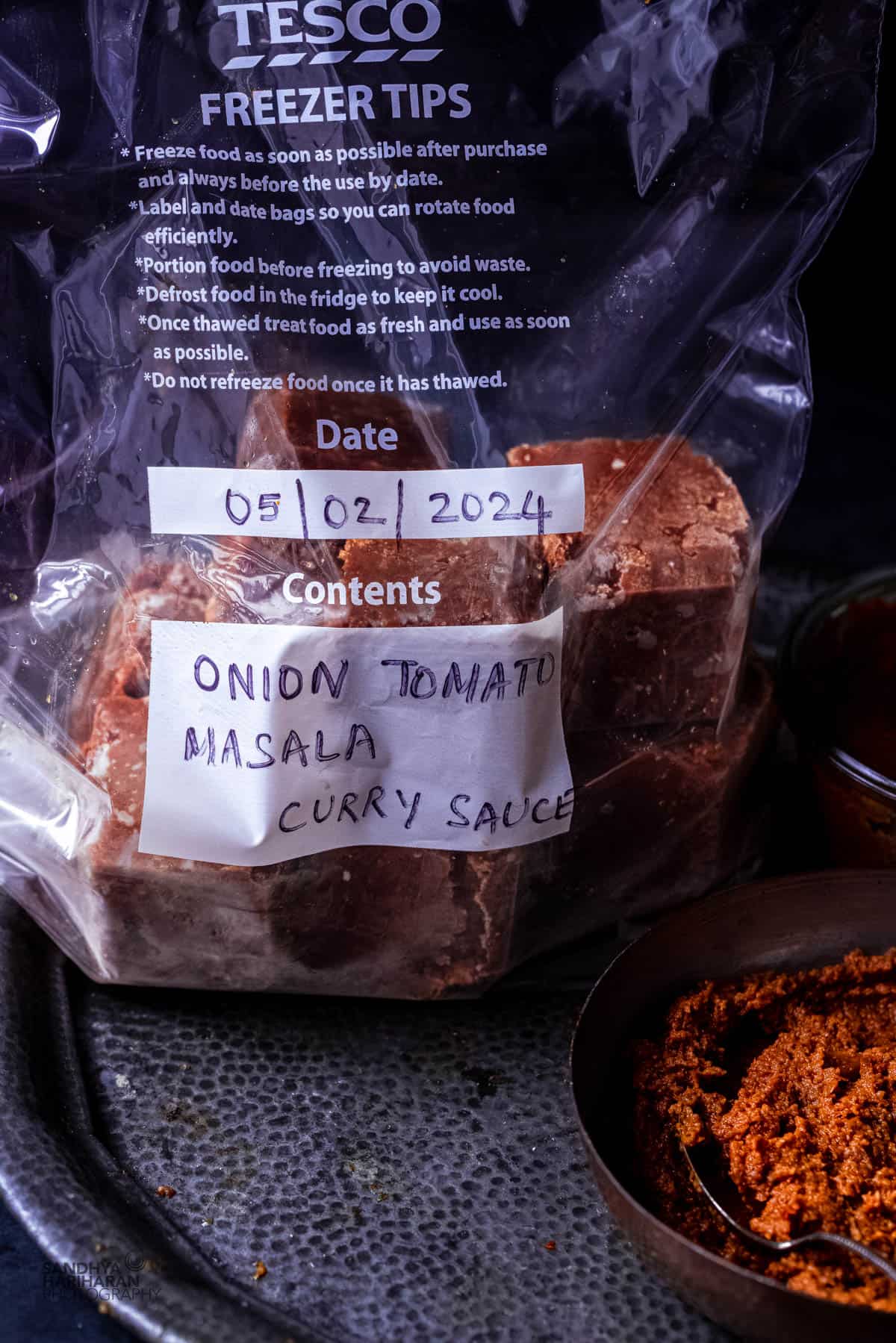 Frozen onion tomato masala in a zip lock bag for later use.