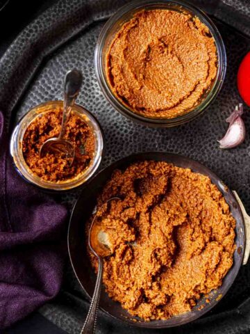 homemade onion tomato masala portioned in different bowls and jars.