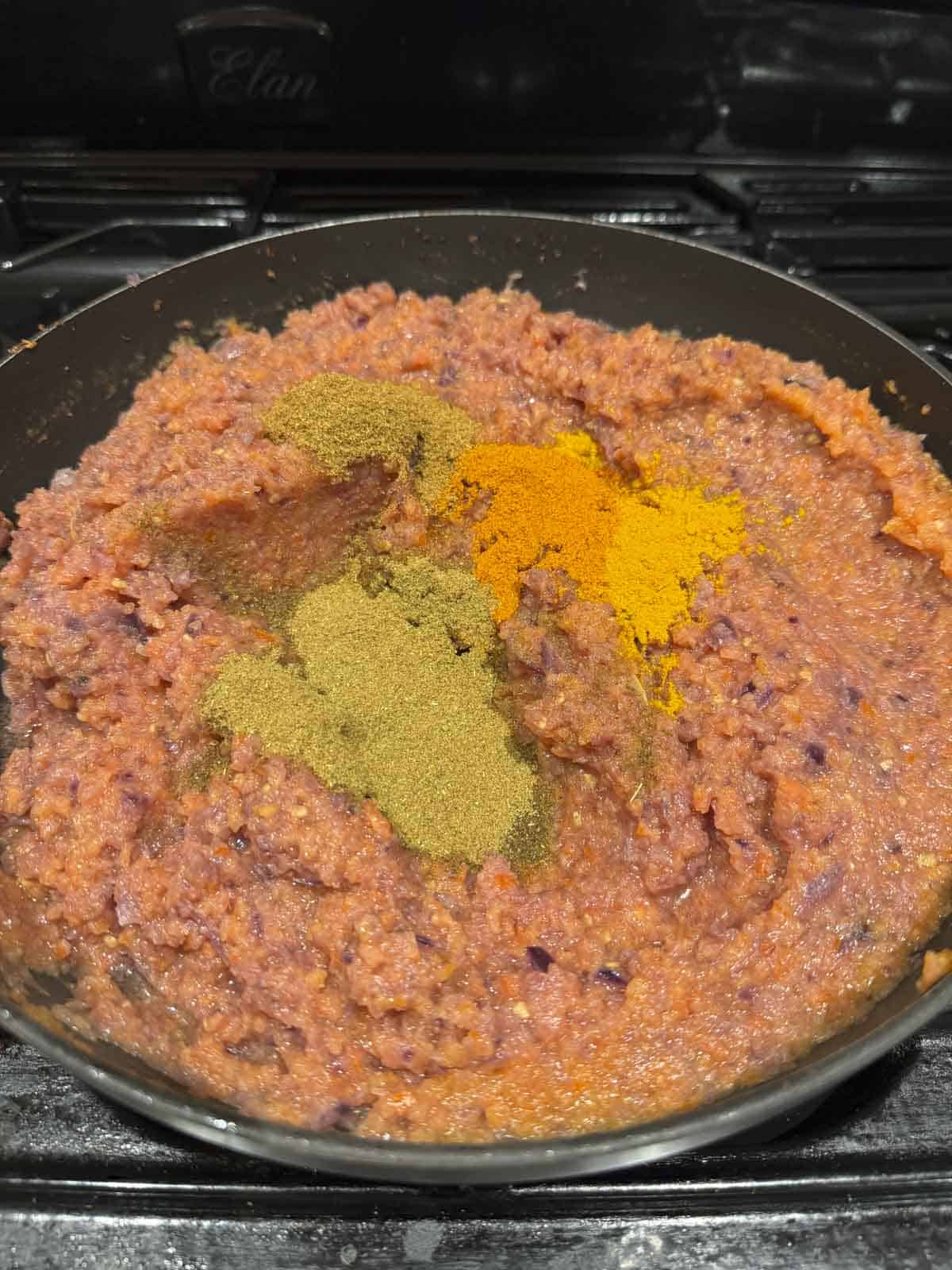 there are spices like turmeric, chilli powder, salt, garam masala, cumin and coriander powder added on top of onion tomato masala.