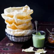 stack of popadoms with indian mint sauce and mango chutney.