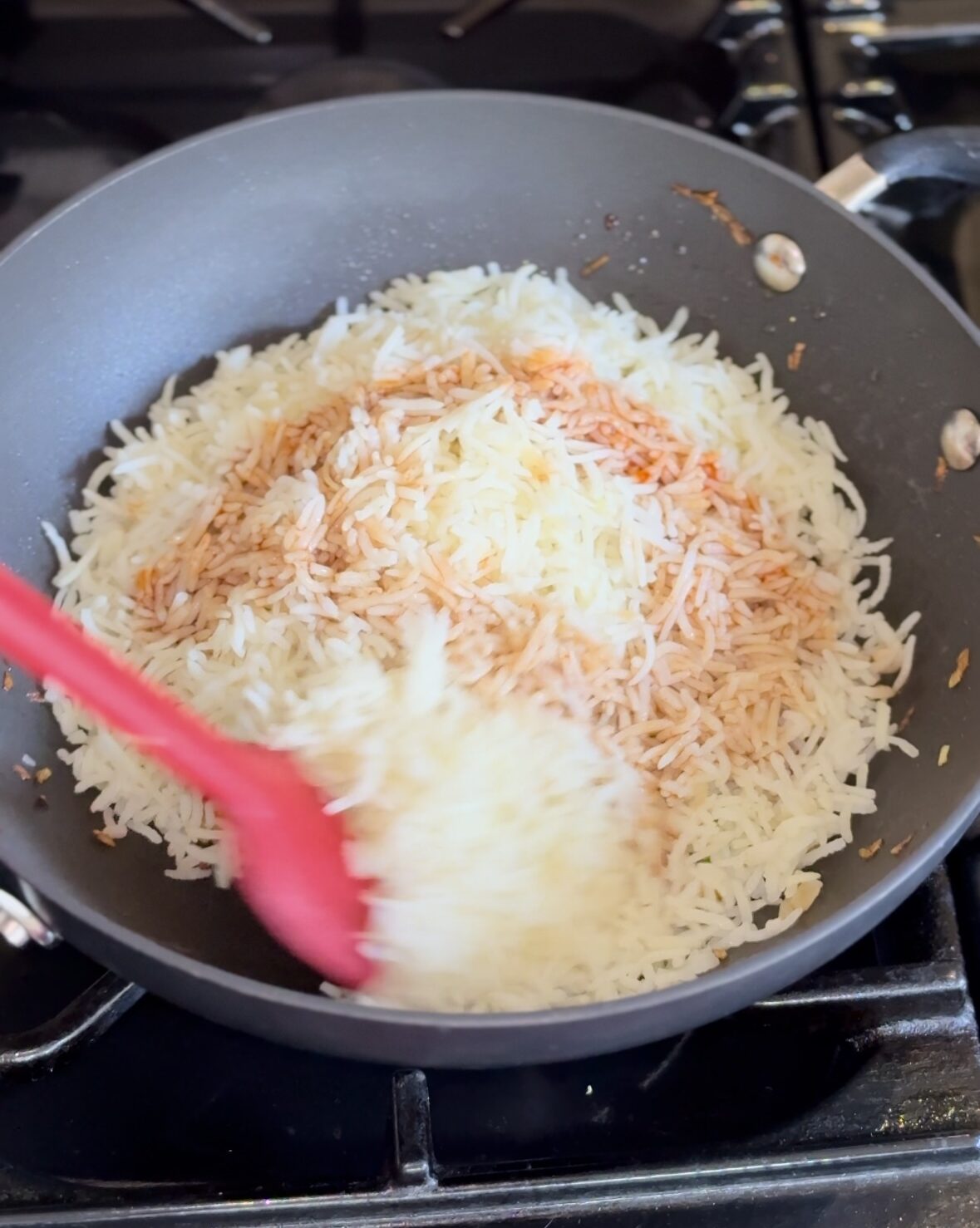 add sauces over rice for tofu fried rice in a wok.